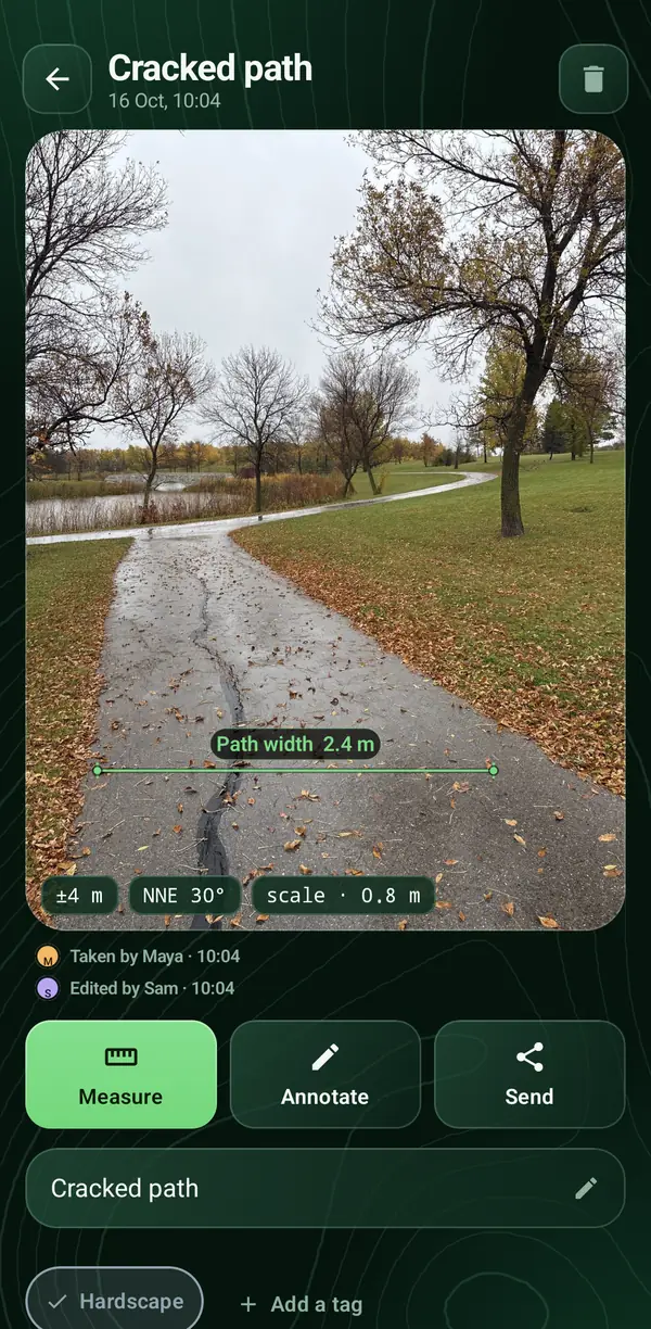 A photo of a cracked park path in the Android app with a path width of 2.4 metres drawn across it, its position accuracy and who took it.